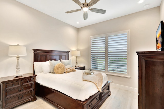 bedroom with light hardwood / wood-style flooring and ceiling fan