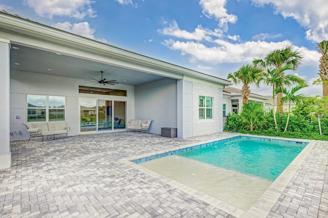 view of swimming pool featuring ceiling fan and a patio