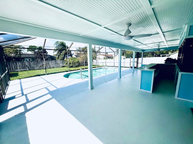 view of swimming pool with a patio area, a lanai, and ceiling fan