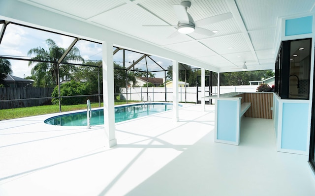 view of pool with ceiling fan, a patio, and a lanai