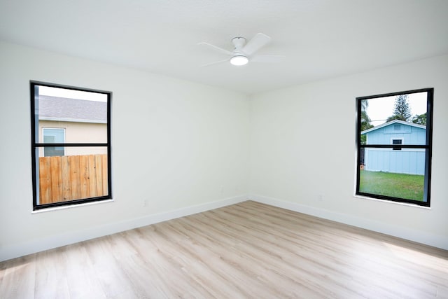 spare room featuring light hardwood / wood-style floors and ceiling fan