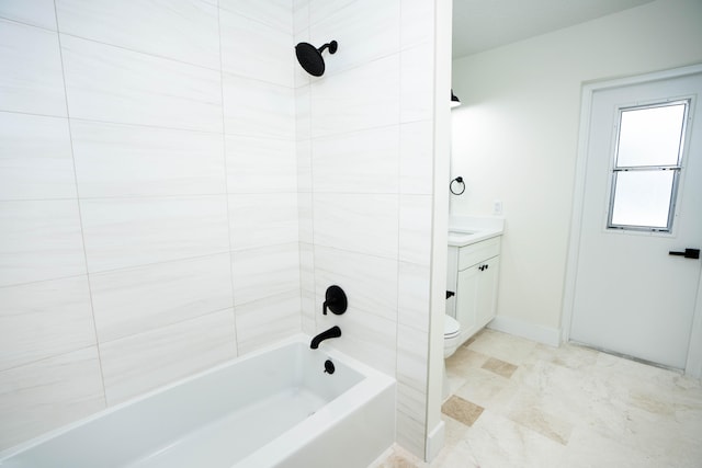 full bathroom with vanity, tiled shower / bath combo, and toilet