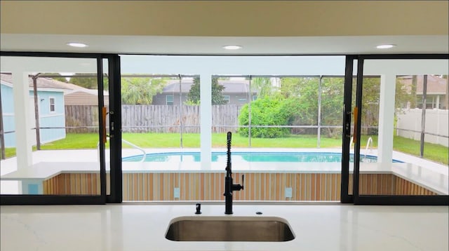 doorway to outside with a wealth of natural light and sink