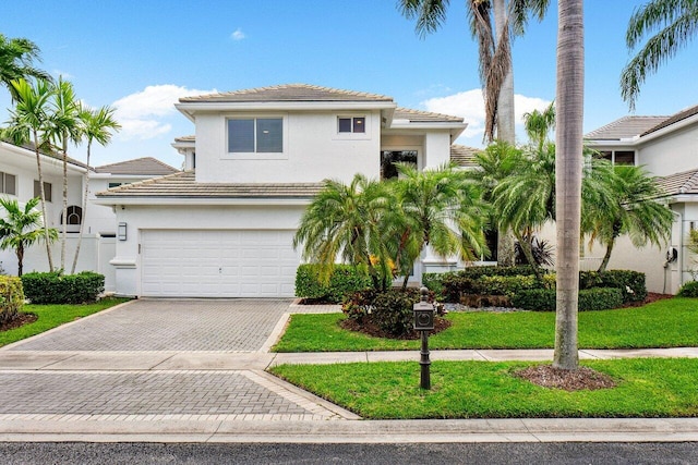 view of front facade featuring a garage and a front lawn