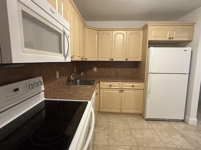 kitchen featuring white appliances, light brown cabinetry, sink, and backsplash