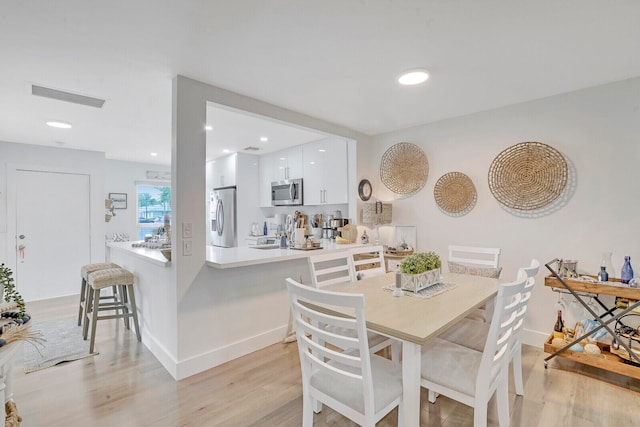 dining area with light wood-type flooring