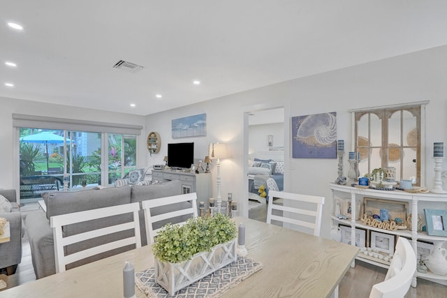 dining area with hardwood / wood-style floors