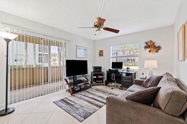 living room with a textured ceiling, light tile patterned floors, and ceiling fan