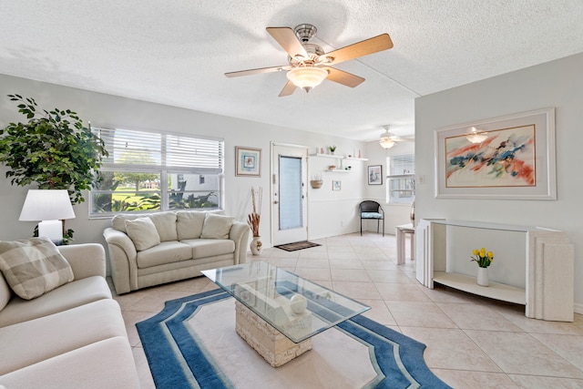 tiled living room featuring a textured ceiling and ceiling fan