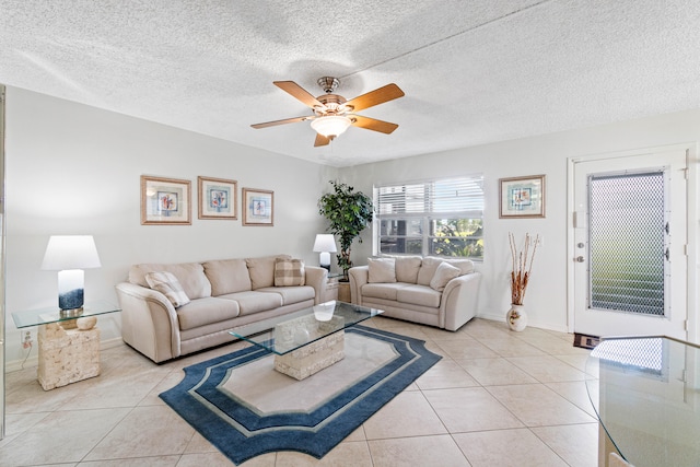 tiled living room with a textured ceiling and ceiling fan