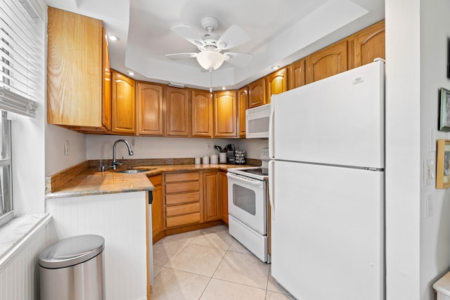 kitchen featuring white appliances, light stone counters, sink, light tile patterned flooring, and ceiling fan