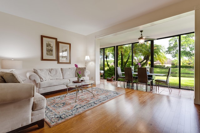 living room with hardwood / wood-style flooring, a wealth of natural light, and ceiling fan