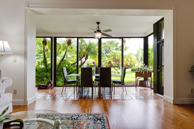 dining space featuring floor to ceiling windows, ceiling fan, plenty of natural light, and light hardwood / wood-style flooring