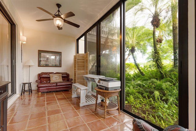 sunroom / solarium with a wealth of natural light and ceiling fan