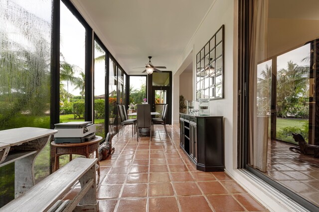 sunroom / solarium with plenty of natural light and ceiling fan