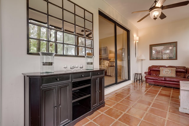 bar featuring light tile patterned floors and ceiling fan