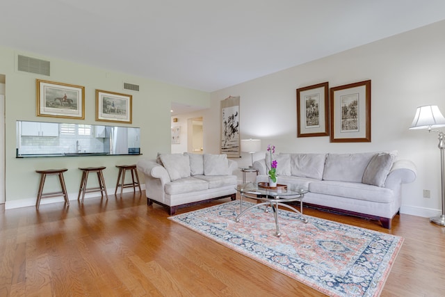 living room with sink and hardwood / wood-style flooring