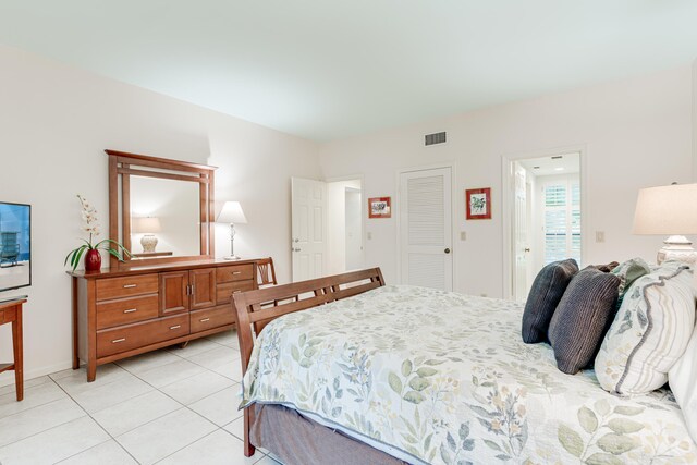 bedroom featuring a closet and light tile patterned floors