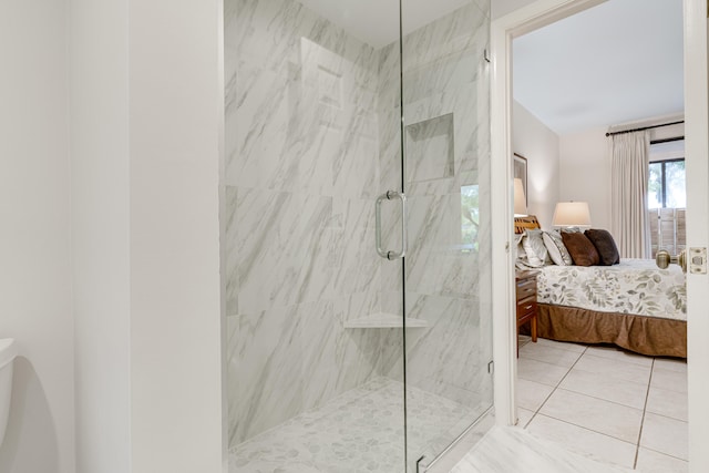 bathroom with a shower with shower door and tile patterned floors