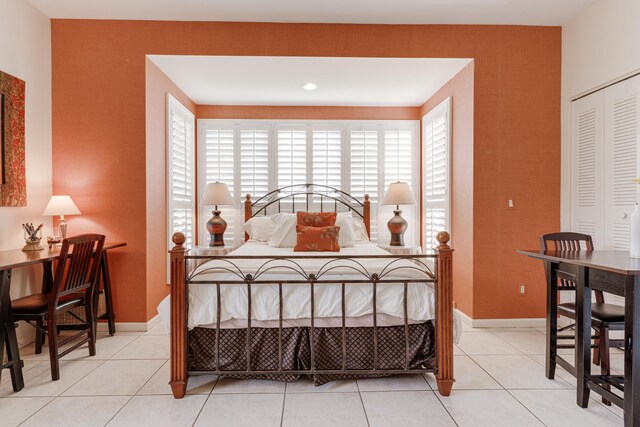 tiled bedroom with a closet