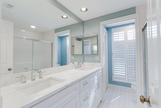 bathroom with an enclosed shower, tile patterned flooring, toilet, and vanity