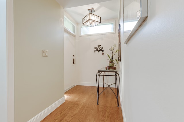 entryway featuring an inviting chandelier and light hardwood / wood-style floors