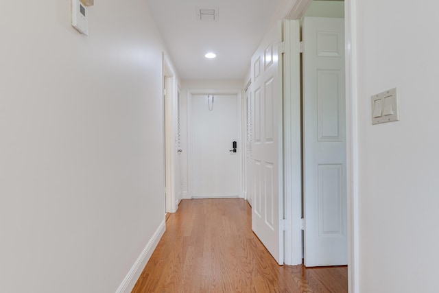 hall with light hardwood / wood-style floors