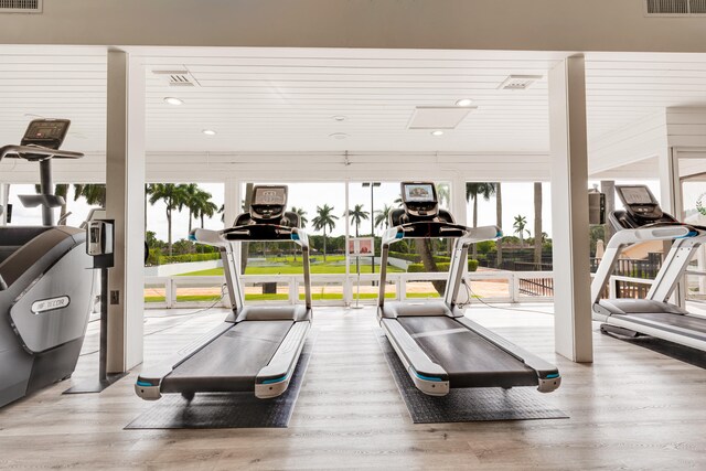 exercise room with hardwood / wood-style floors