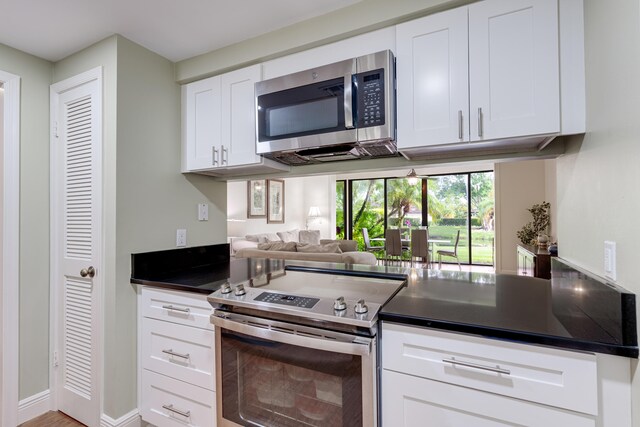 kitchen featuring stainless steel appliances and white cabinetry