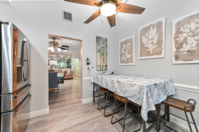 dining space featuring light hardwood / wood-style flooring and ceiling fan