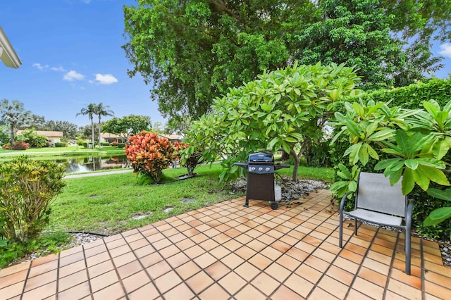 view of patio / terrace with a water view and grilling area