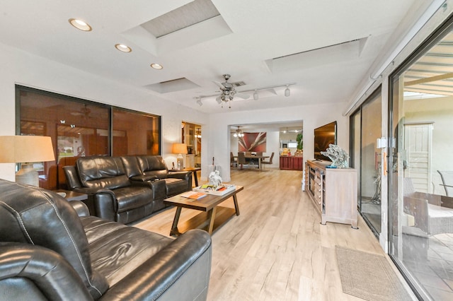 living room featuring ceiling fan and light wood-type flooring