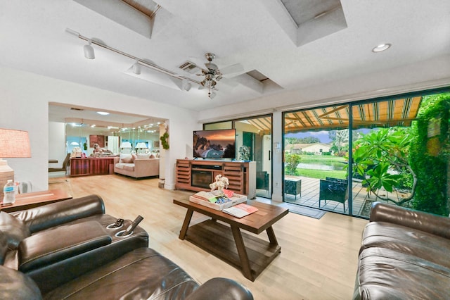 living room featuring ceiling fan and hardwood / wood-style flooring