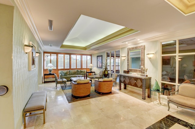 living room with crown molding and a raised ceiling