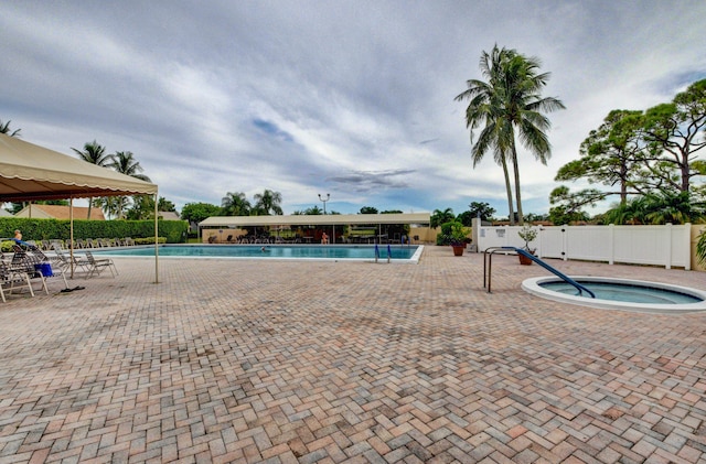 view of pool with a community hot tub and a patio