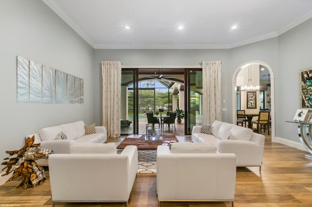 living room featuring crown molding and light hardwood / wood-style floors