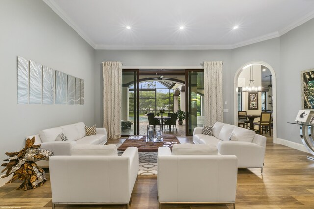 11780 Otter Run, Lake Worth, FL 33449 - living room featuring crown molding, arched walkways, wood finished floors, and recessed lighting