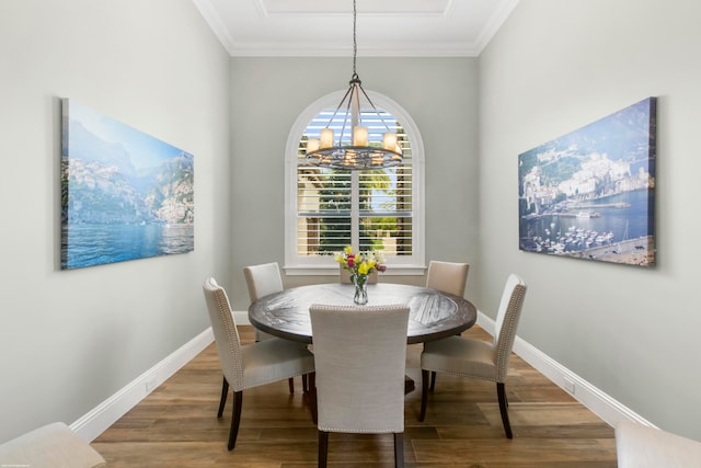 dining space featuring a notable chandelier, hardwood / wood-style flooring, and ornamental molding