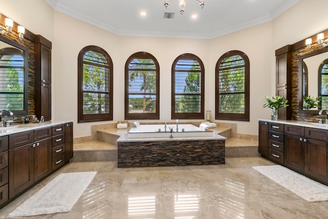 bathroom featuring vanity, a relaxing tiled tub, and a wealth of natural light