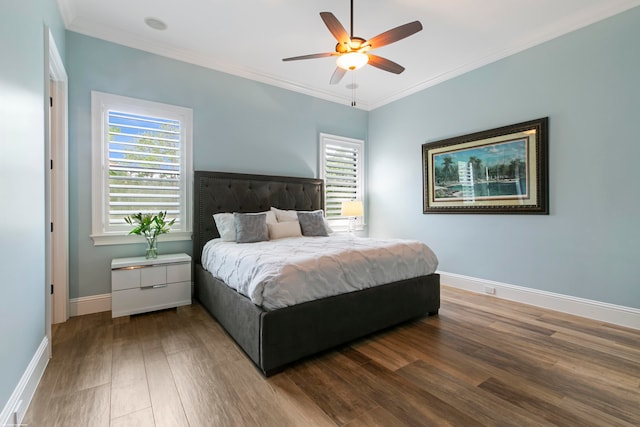 bedroom with multiple windows, crown molding, dark hardwood / wood-style flooring, and ceiling fan