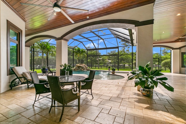 view of patio featuring pool water feature, glass enclosure, and ceiling fan