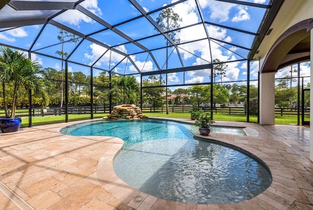 view of pool featuring a patio, a yard, and a lanai