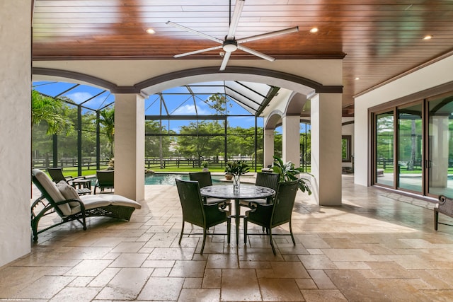 view of patio / terrace with a lanai and ceiling fan