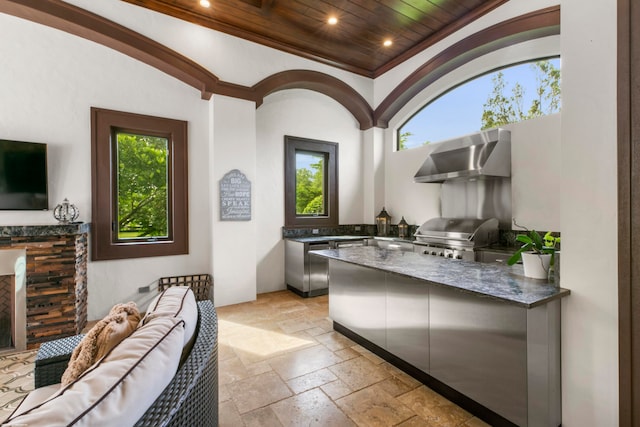 interior space featuring ornamental molding, wall chimney range hood, and wooden ceiling