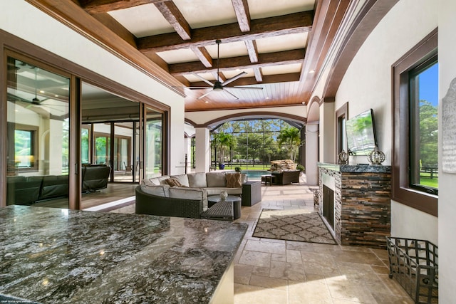 view of patio with outdoor lounge area, ceiling fan, and exterior kitchen