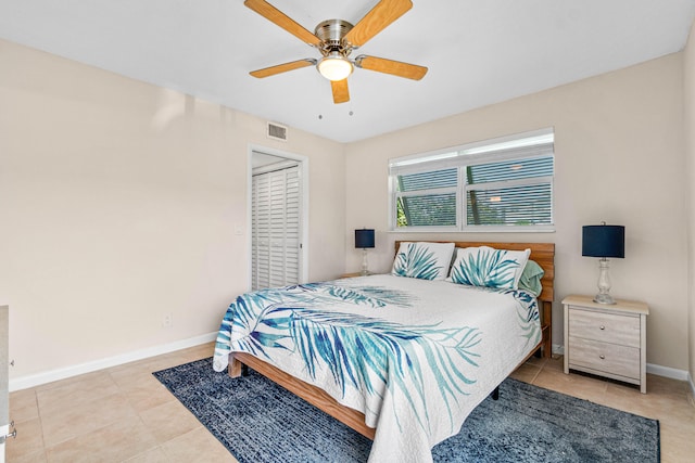 bedroom with a closet, ceiling fan, and light tile patterned floors