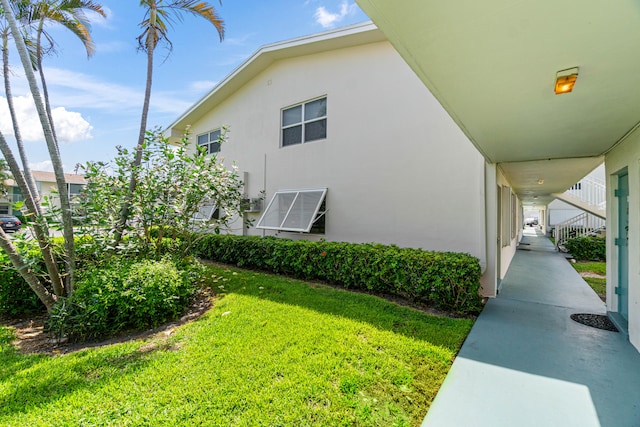 view of side of property with a lawn