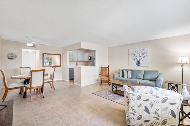 living room with a textured ceiling and ceiling fan