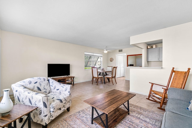 tiled living room featuring a textured ceiling and ceiling fan