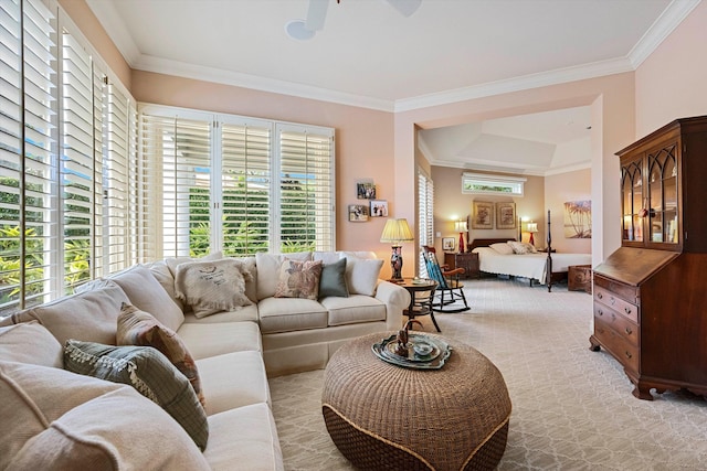 carpeted living room featuring ornamental molding and ceiling fan